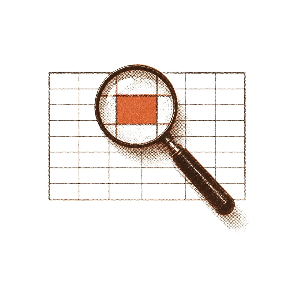 A magnifying glass over a printed grid, one cell marked in orange.